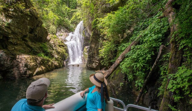 picture of couple on a pontoon boat viewing waterfall