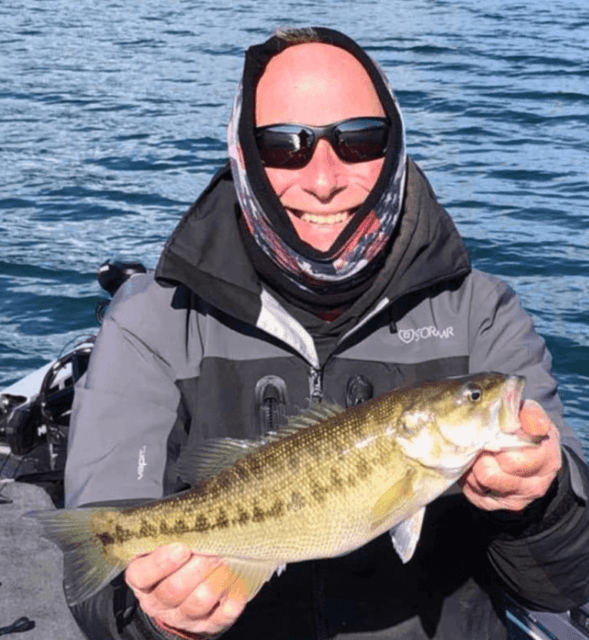 Guide Charles Townson shows off a healthy Keowee spotted bass caught with the author