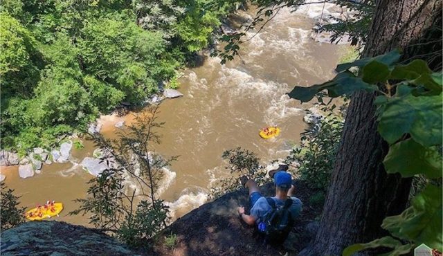 aerial photo of person looking down on rafting trip