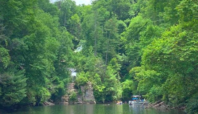 pic of a boat near waterfall on Lake jocassee