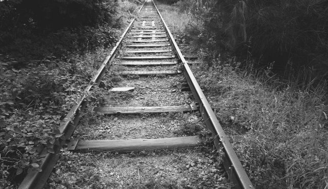 black and white photo of railroad track