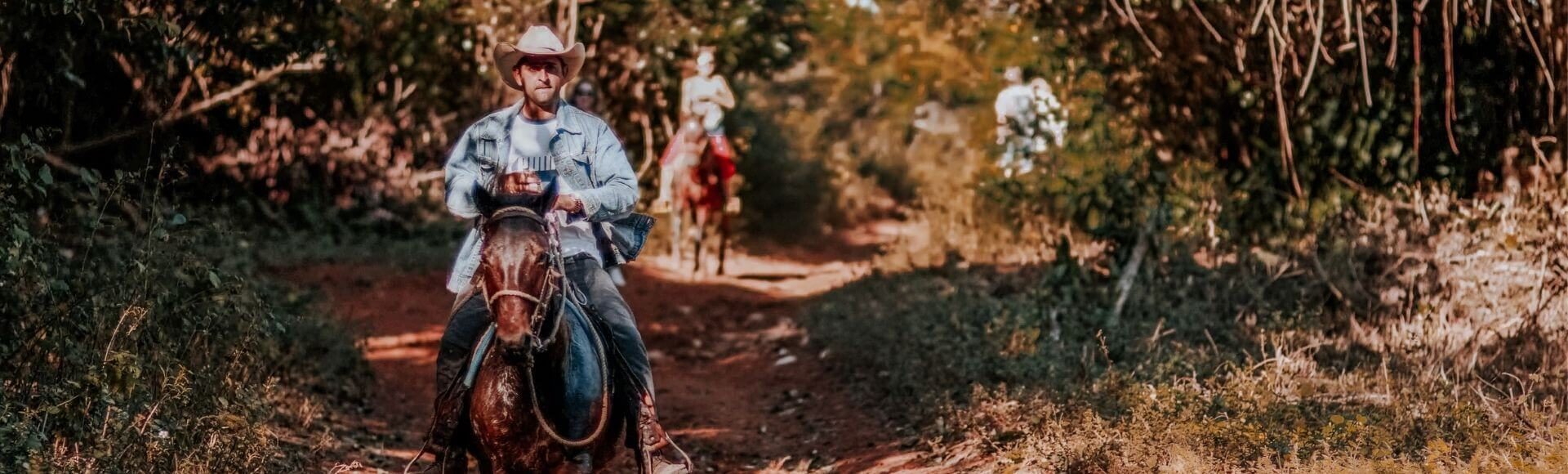 photo of man riding a horse