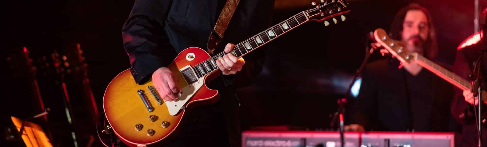 image of man playing a guitar