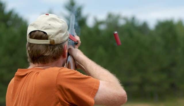photo of man shooting shotgun