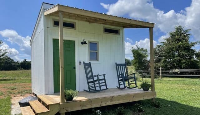 photo of tiny home with green door on horse farm