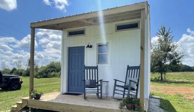 Image of tiny home farm stay with blue door