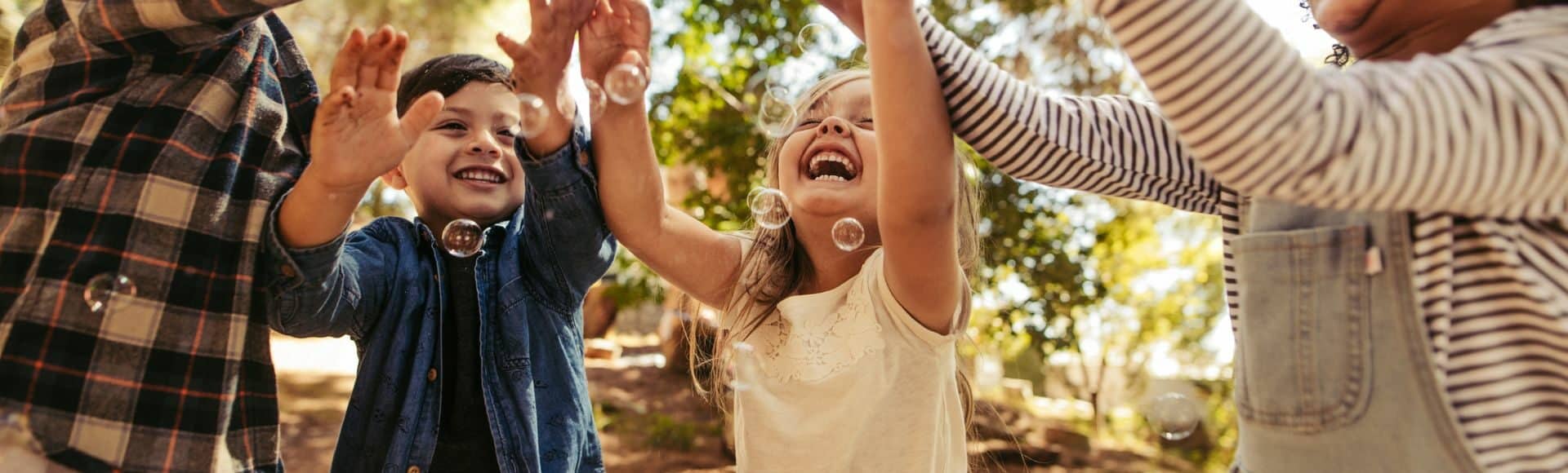 photo of kids playing with bubbles