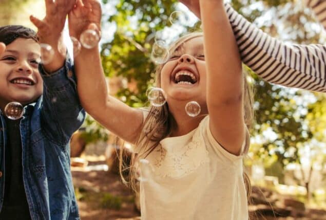 photo of kids playing with bubbles