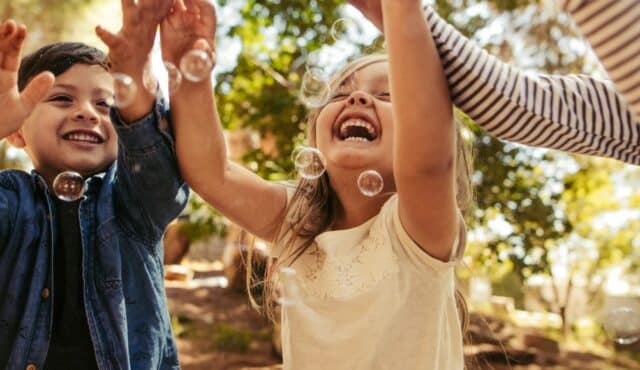 photo of kids playing with bubbles