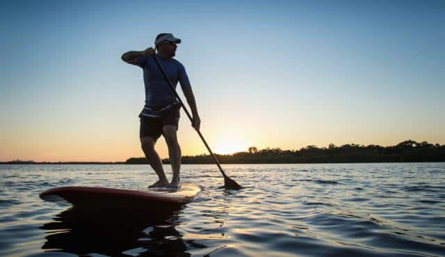 photo of man on paddle board