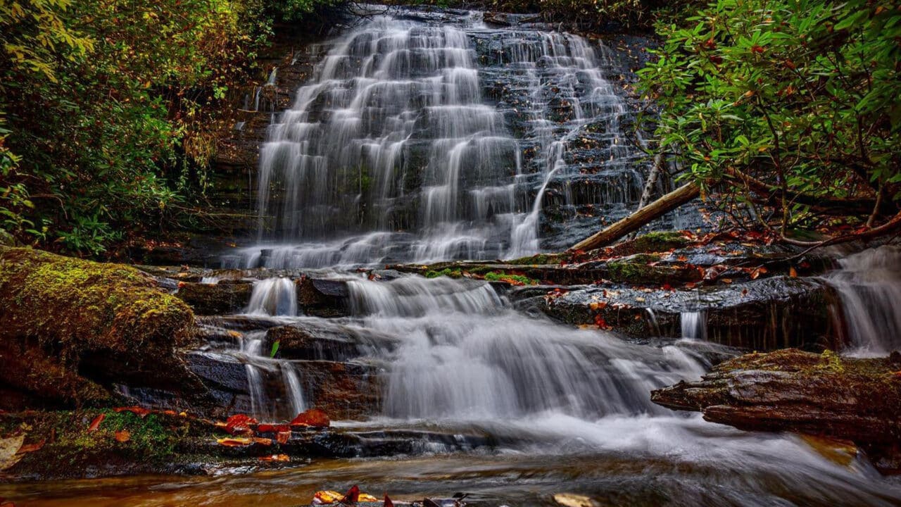 Brasstown Falls cascades amid vibrant fall color in Oconee County, ideal for your right fall hike.